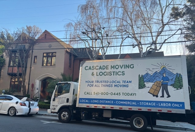 Cascade Moving truck in front of apartment building